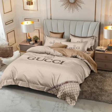 Beige bedding with large lettering and a dark geometric border.